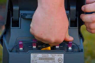 En person som håller i en produkt som visar batterifacket.